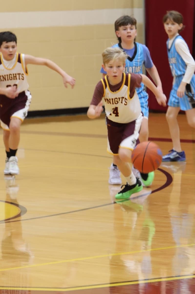 Player dribbling in a Knights uniform