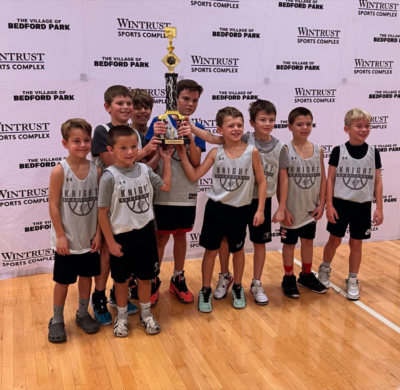 Jr Knights team celebrating with a trophy