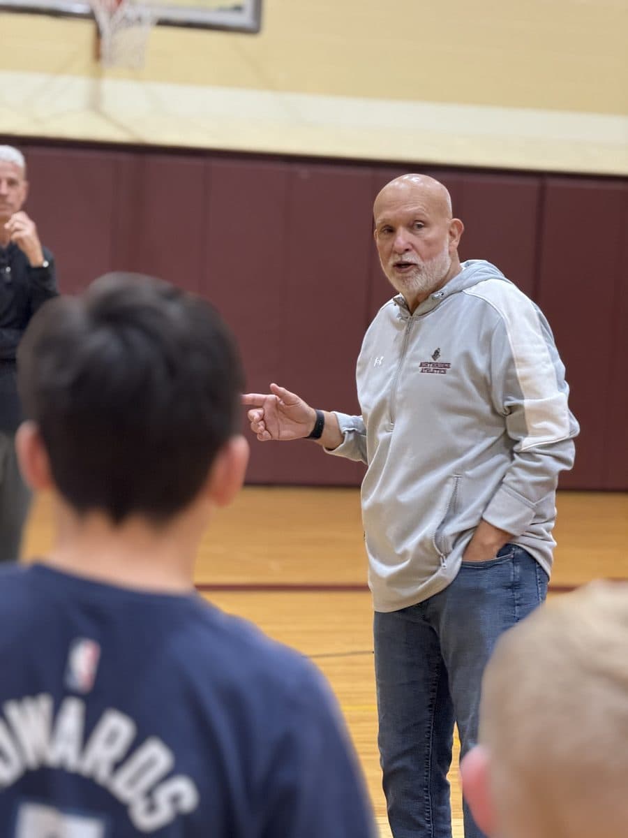 Coach Will Rey giving instruction to players in the Northridge Prep gym
